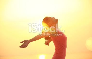 FPOstock-photo-38957304-cheering-woman-open-arms-under-sunrise-on-beach